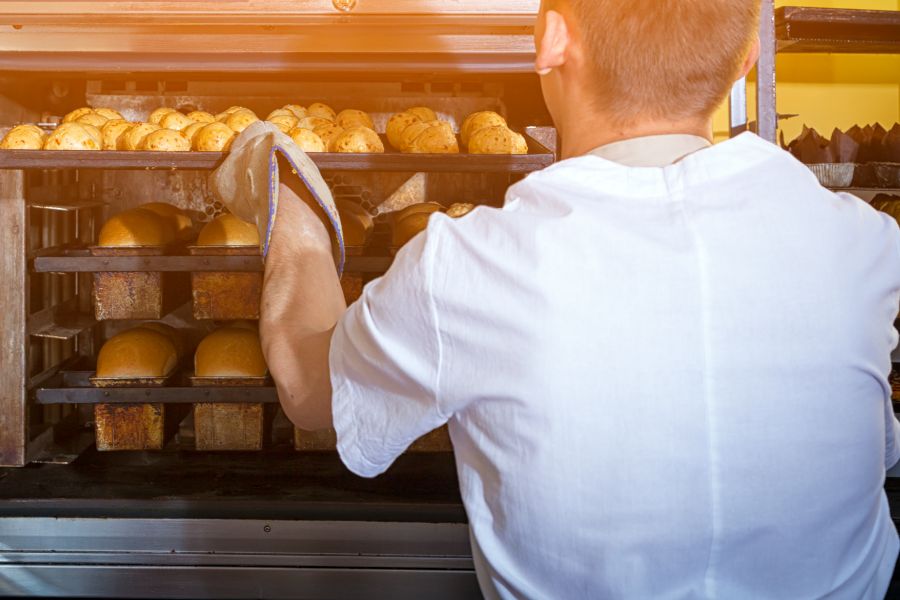 Chef taking bread out of convection oven